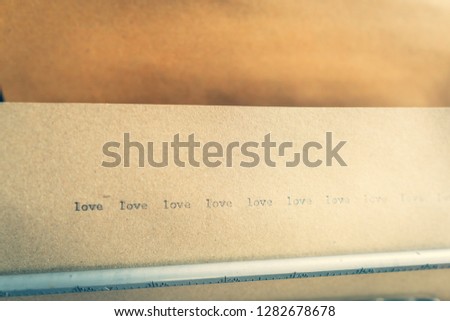 Typewriter typed love words on brown paper