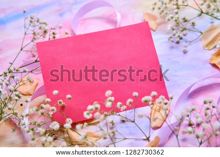 pink card, Background for greeting card women's day, Valentine's day. White flowers, yellow rose Petals, pink ribbons lie on a watercolor background in delicate pink, blue, yellow shades