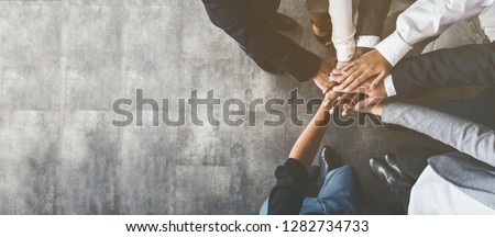 Unity and teamwork. Business people putting their hands together, top view, copy space Royalty-Free Stock Photo #1282734733
