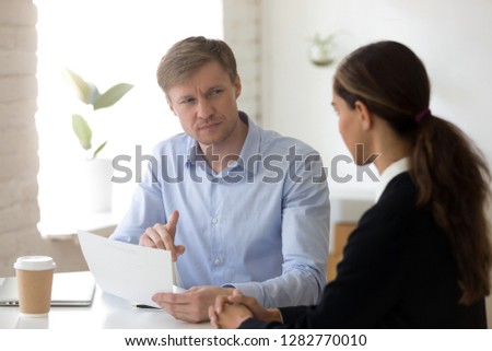 Doubting hr manager having questions for applicant at job interview, recruiter read bad resume, looking with suspicion, dishonest job seeker, boss dissatisfied employee work results, contract fraud Royalty-Free Stock Photo #1282770010