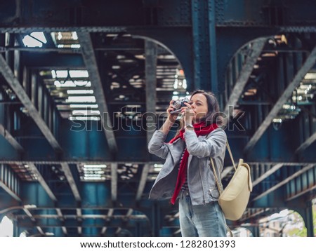 Young photographer with a retro photo camera on the street in New York