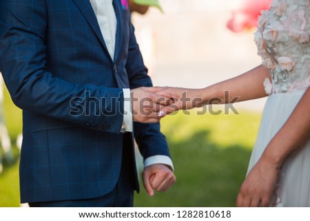 bride and groom hold hands Royalty-Free Stock Photo #1282810618