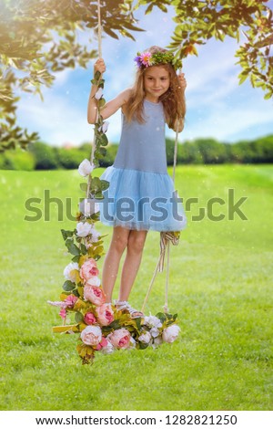 Girl on the swing decorated with flowers
