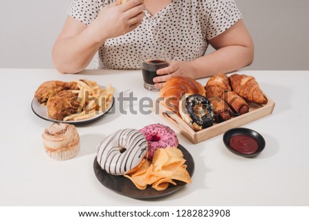 Curvy female preparing to eat hamburger, overeating problem, depression Royalty-Free Stock Photo #1282823908