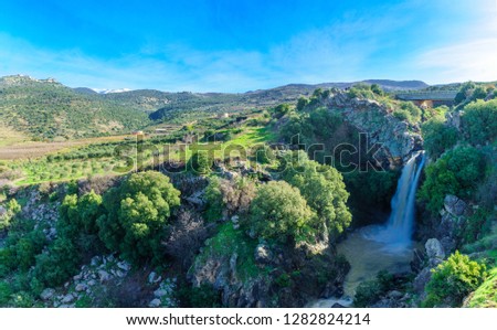 View of the Saar Waterfall, with Mount Hermon and Nimrod Fortress in the background, in the Golan Heights, Morthern Israel Royalty-Free Stock Photo #1282824214