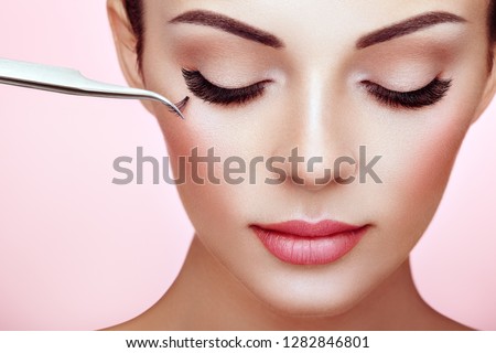 Beautiful Woman with Extreme Long False Eyelashes. Eyelash Extensions. Makeup, Cosmetics. Beauty, Skincare. Woman Glues Eyelashes Royalty-Free Stock Photo #1282846801