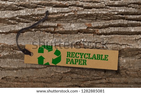 Recycle tag on bark tree