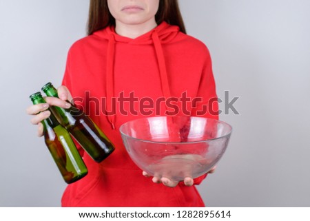 Cropped closeup photo of disappointed confused grimacing person holding showing empty plate isolated gray background