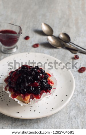 Fruit tart with berries on a white plate close up