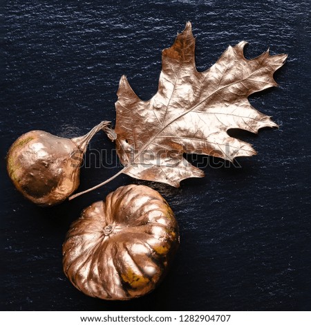 The decorative golden leaf and pumpkins on the slate platter
