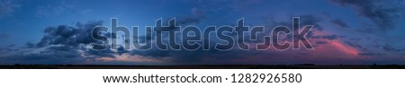 
Panorama of dramatic sunset sky with clouds Royalty-Free Stock Photo #1282926580