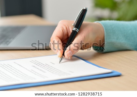 Cropped shot of a businesswoman hand signing a contract on a desk at office