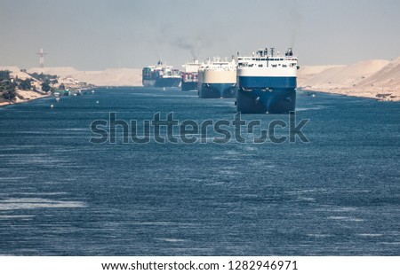 The Suez Canal is a shipping canal in Egypt.A cargo ship drives the Suez Canal. Royalty-Free Stock Photo #1282946971