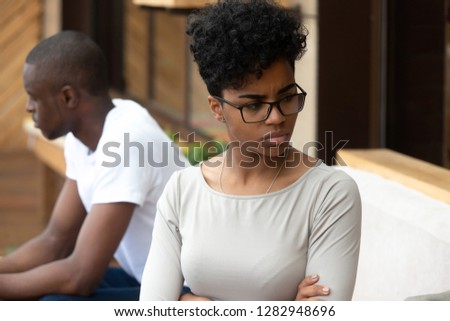 African american unhappy couple sitting on sofa after quarrel fight thinking about break up or divorce. Frustrated black upset female and male not talking having conflict. Bad relationships concept Royalty-Free Stock Photo #1282948696