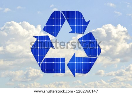 Ecology concept: recycling. Recycling symbol fill by solar panel texture on blue cloudy sky background.