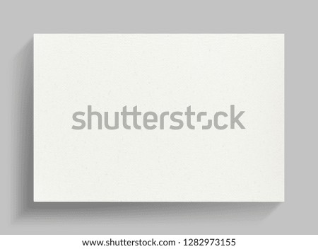 White canvas frame on gray wall background with soft shadow.