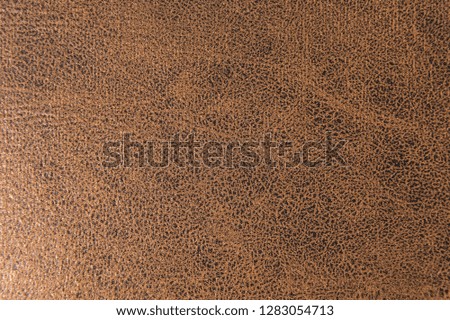 Textured background surface of textile upholstery furniture close-up. leatherette brown color fabric structure