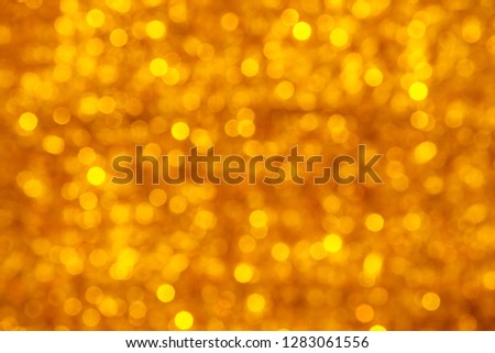 Abstract blurred shiny yellow background with bright lights.