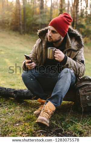 Young blogger photographer travel in mountain forest