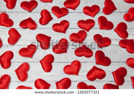 Red hearts on a wooden background, concept of love and loyalty