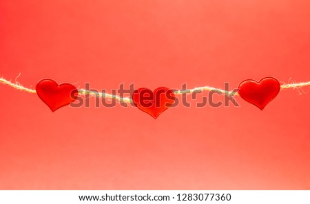 Red hearts on light red background, strong love concept