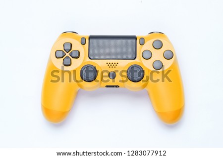 Modern yellow gamepad (joystick) on gray background. Top view Royalty-Free Stock Photo #1283077912
