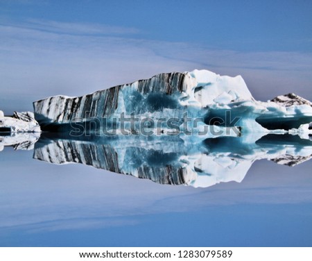 A picture of an Iceberg in the Jokulsaron Lagoon in Iceland with reflection