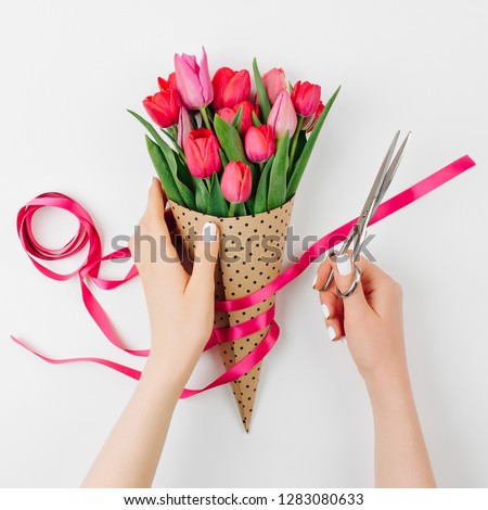  Female Hands with Tulips Bouquet. Beautiful Spring Pink flowers.