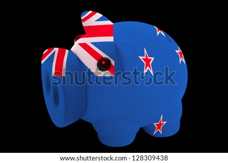 piggy rich bank in colors national flag of new zealand for saving money on black background