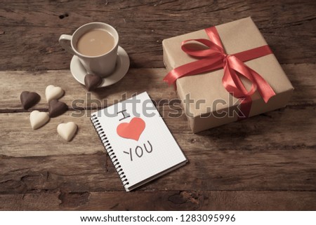 Beautiful Valentines composition of gift, chocolate heart shaped, coffee and noted pad with I love you heart symbol text in Happy Valentines, Mothers and fathers day and love celebration concept.