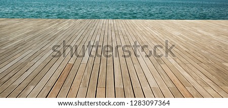 simple panoramic background wallpaper pattern of wooden deck floor sea waterfront perspective foreshortening material surface with empty copy space for your text or inscription  Royalty-Free Stock Photo #1283097364