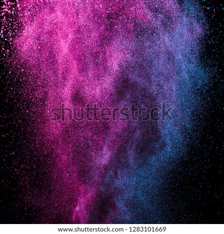 Splash of colourful powder on black background