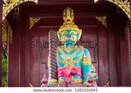 Colourful statue at buddhist gold temple in Thailand at the sunset