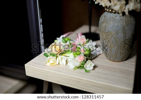 rose boutonnieres on shelf at home