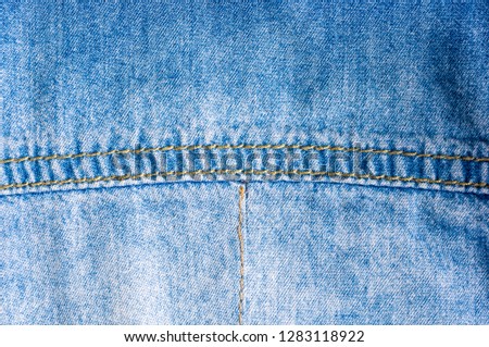 Blue washed faded jeans texture with seams