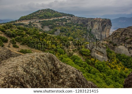 panorama landscape pilgrim and travel touristic site concept photography of beautiful scenic view to steep rocks in south Europe district in Greece with monastery on top of mountains