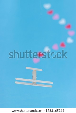 Little Wooden Airplane Trailing Red, White and Pink Hearts Valentine Concept Depth of Field