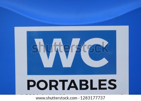 Bright blue sign for portable toilets close up