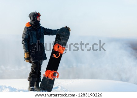 awesome athlete standing on the peak of the mountains and looking into the distance. close up side view photo. copy space