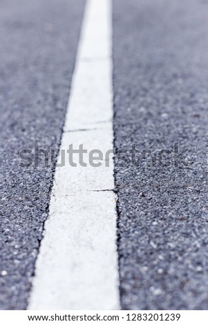 Closeup photo of the road with white line