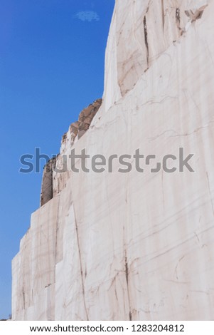Marble quarry landscape in the mountains with a turquoise lake water