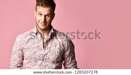 Young successful happy smiling business man in shirt standing posing on pink background with text space. Banner