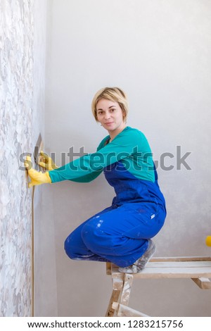 Wallpaper gluing / Girl doing repairs