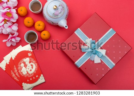 Chinese new year festival decoration with orange flower and packet in Red theme - Chinese characters mean happiness,  great luck, great profit