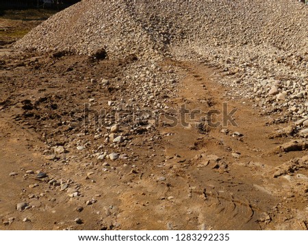 Muddy ground after rain. Extreme path rural dirt road in the hills. Wheel off-road track in a countryside landscape with a muddy road.