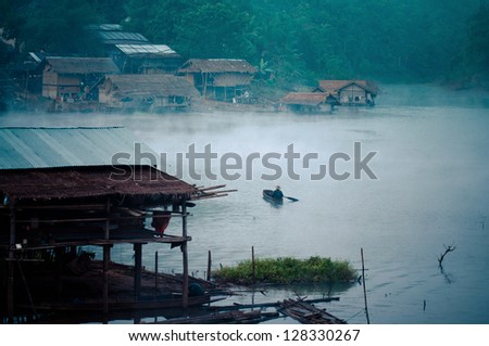 The fishermen in a small boat on a lake