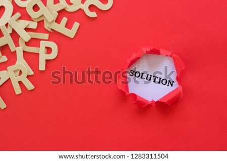 Business concept. Torn red paper with Solution text on white background.