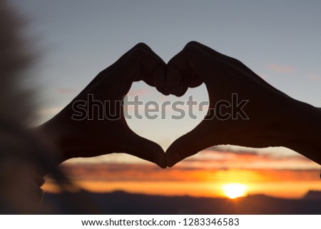 Woman making heart shape during sun rise, God is love concept, Heart shape, Mountain tourism, Symbol of love, The manifestation of love, Expression of feelings. Love of nature,  Royalty-Free Stock Photo #1283346583