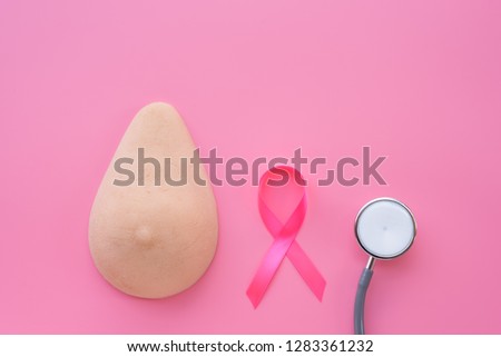 Breast model, pink ribbon and stethoscope on pink background.Health education for breast self exam (BSE).Breast cancer awareness and self check, healthy lifestyle concept.