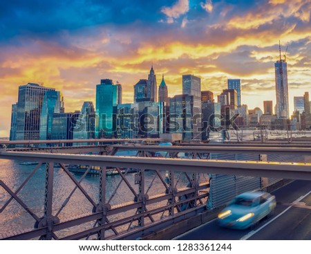 Traffic over Brooklyn Bridge at sunset.